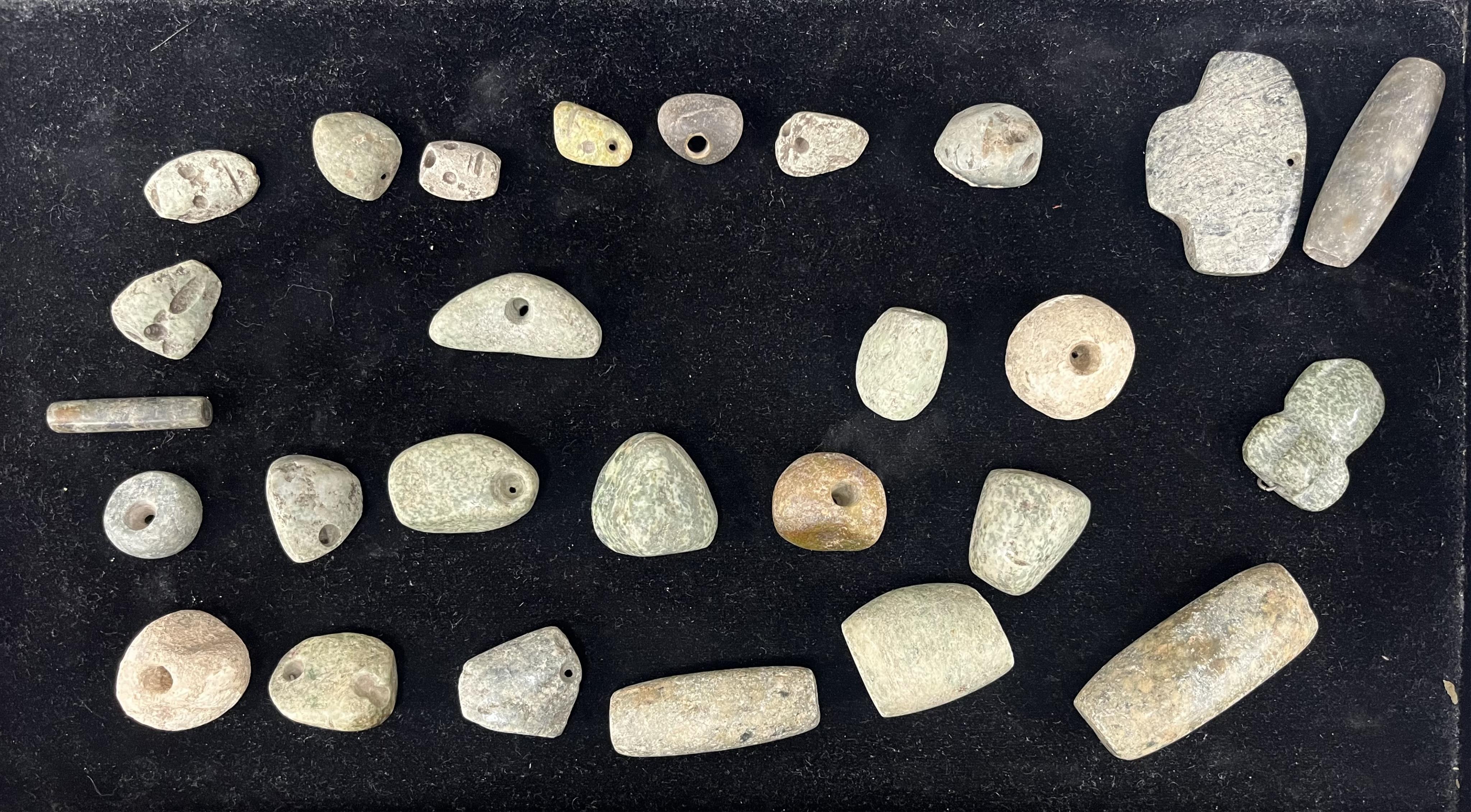 A group of pre-Colombian jadeite and stone beads from a necklace, and three similar jadeite pendants, Mesoamerican